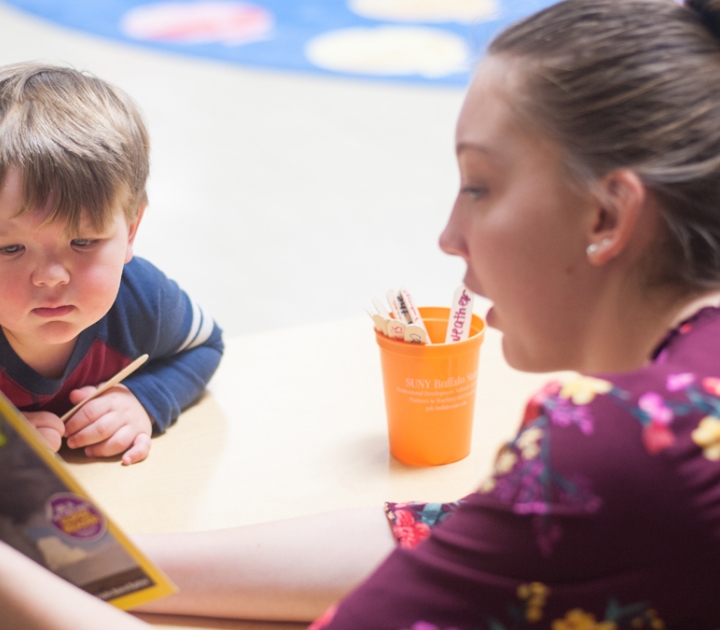 A woman reading to a child