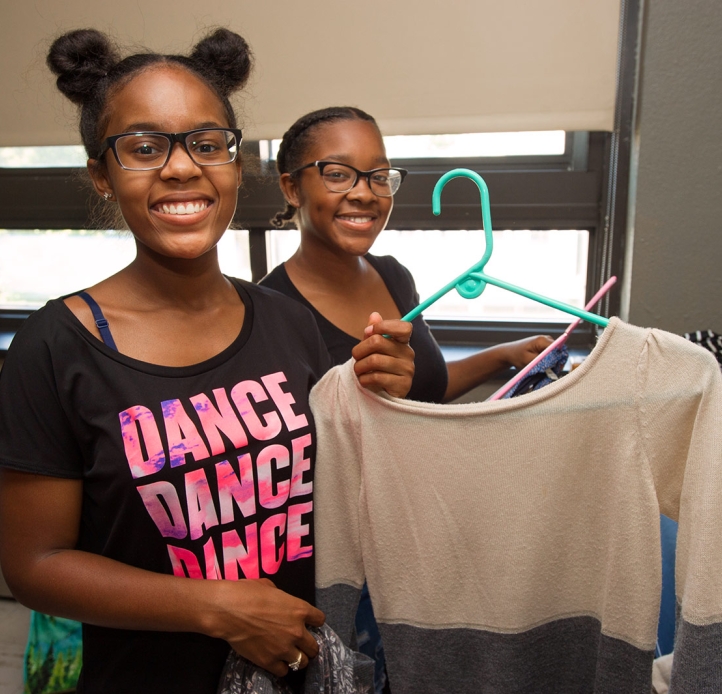 Students smiling in dorm room