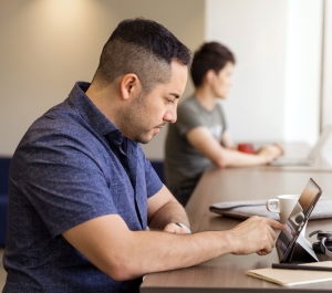 Adult student with a laptop on a table