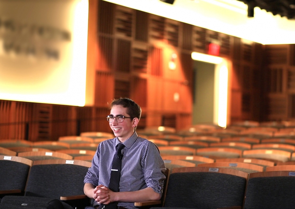 Tanner McMullen sitting in Ciminelli Recital Hall